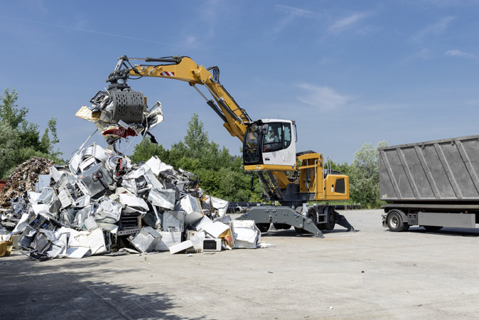 The Liebherr LH 22 M material handling machine at the NordBau 2014 trade fair