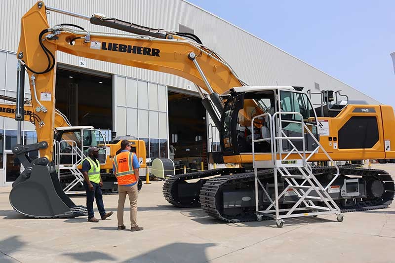 Customers touring  the R  945 crawler excavator at the Liebherr Equipment Source open house event at the Liebherr USA, Co. Newport News, VA campus.