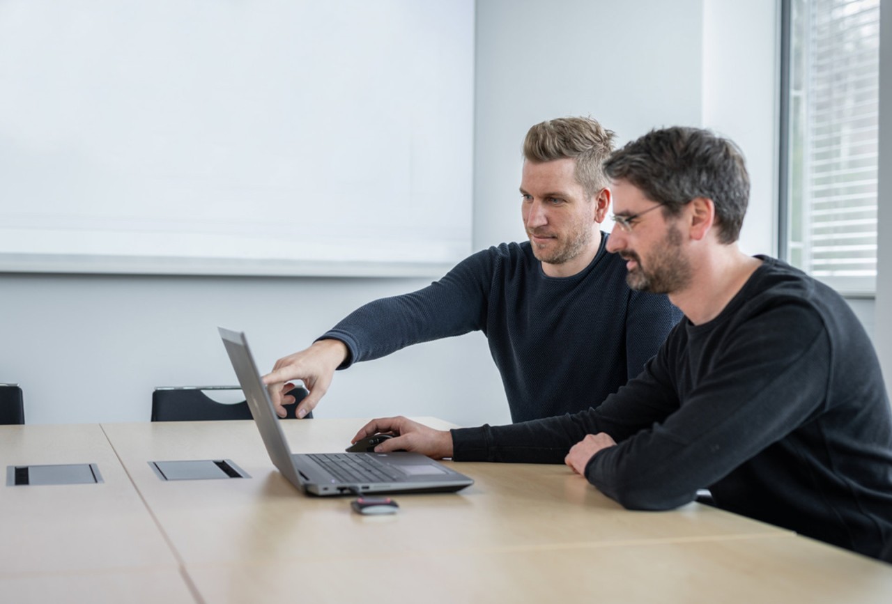 Two Liebherr employees planning and discussing CFRP products