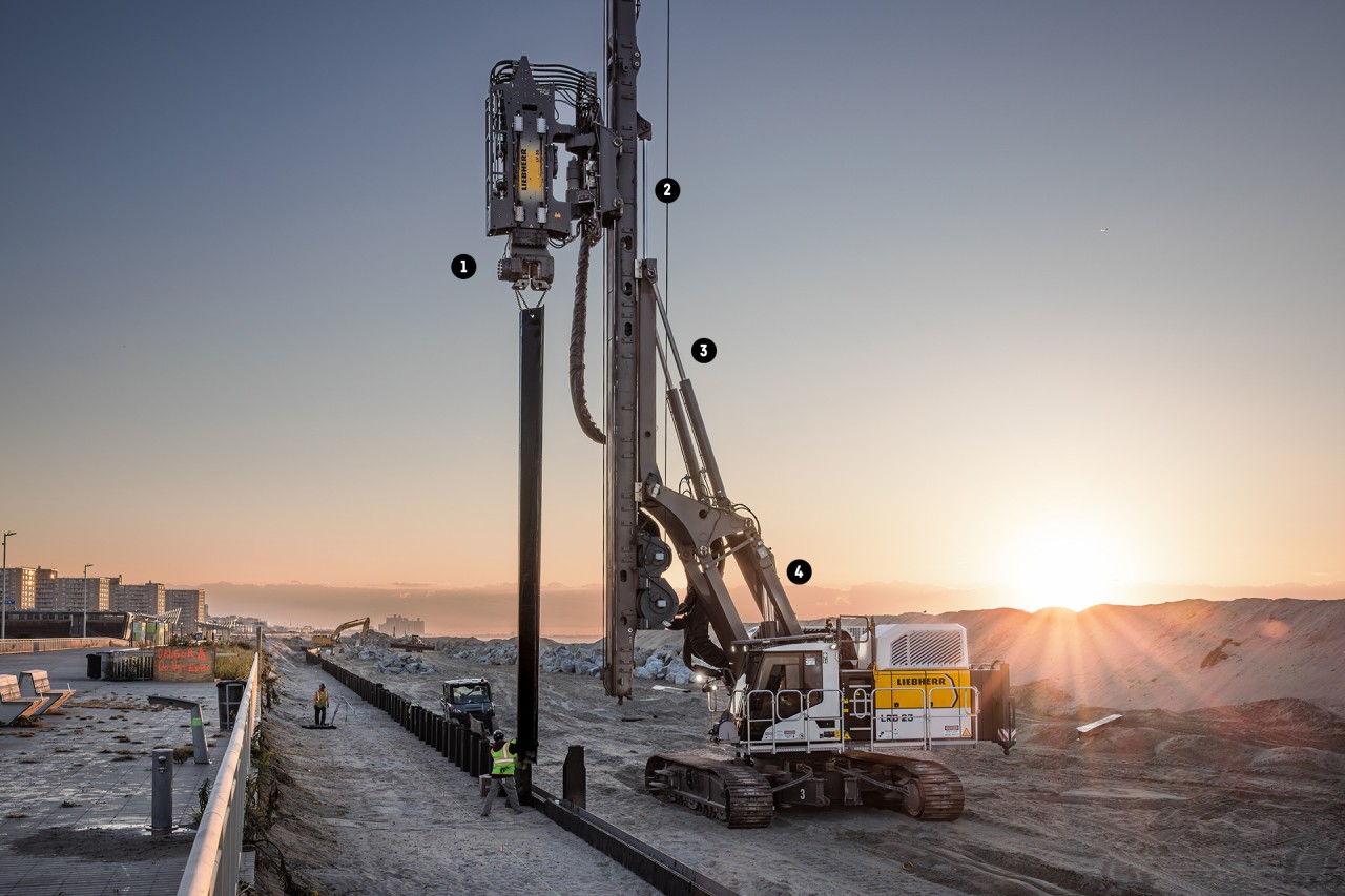 LRD 23 Ramm- und Bohrgerät auf einer Baustelle bei Sonnenuntergang, mit verschiedenen markierten Hydraulikzylindern von Liebherr