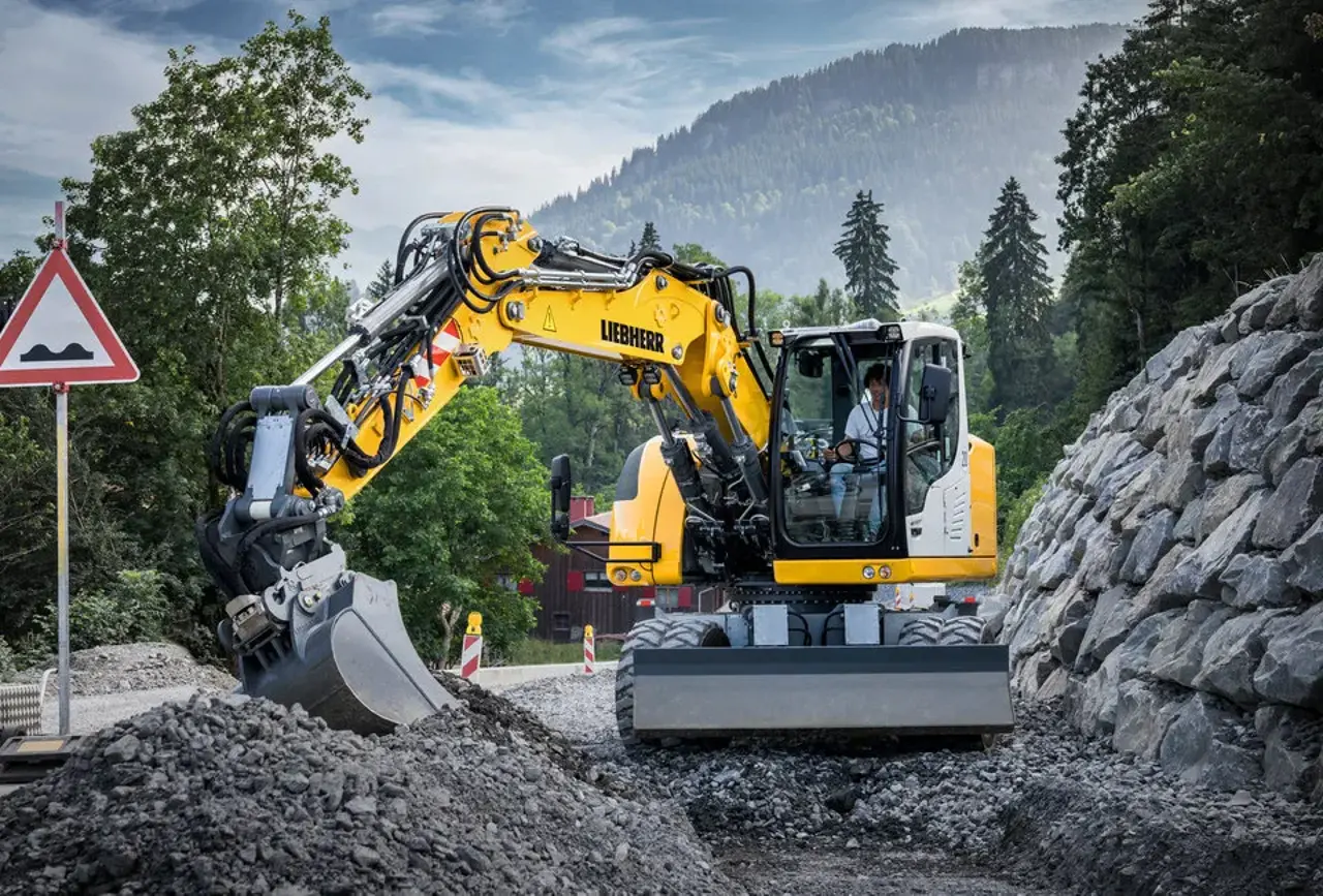 Compact wheeled excavator pulls trenches