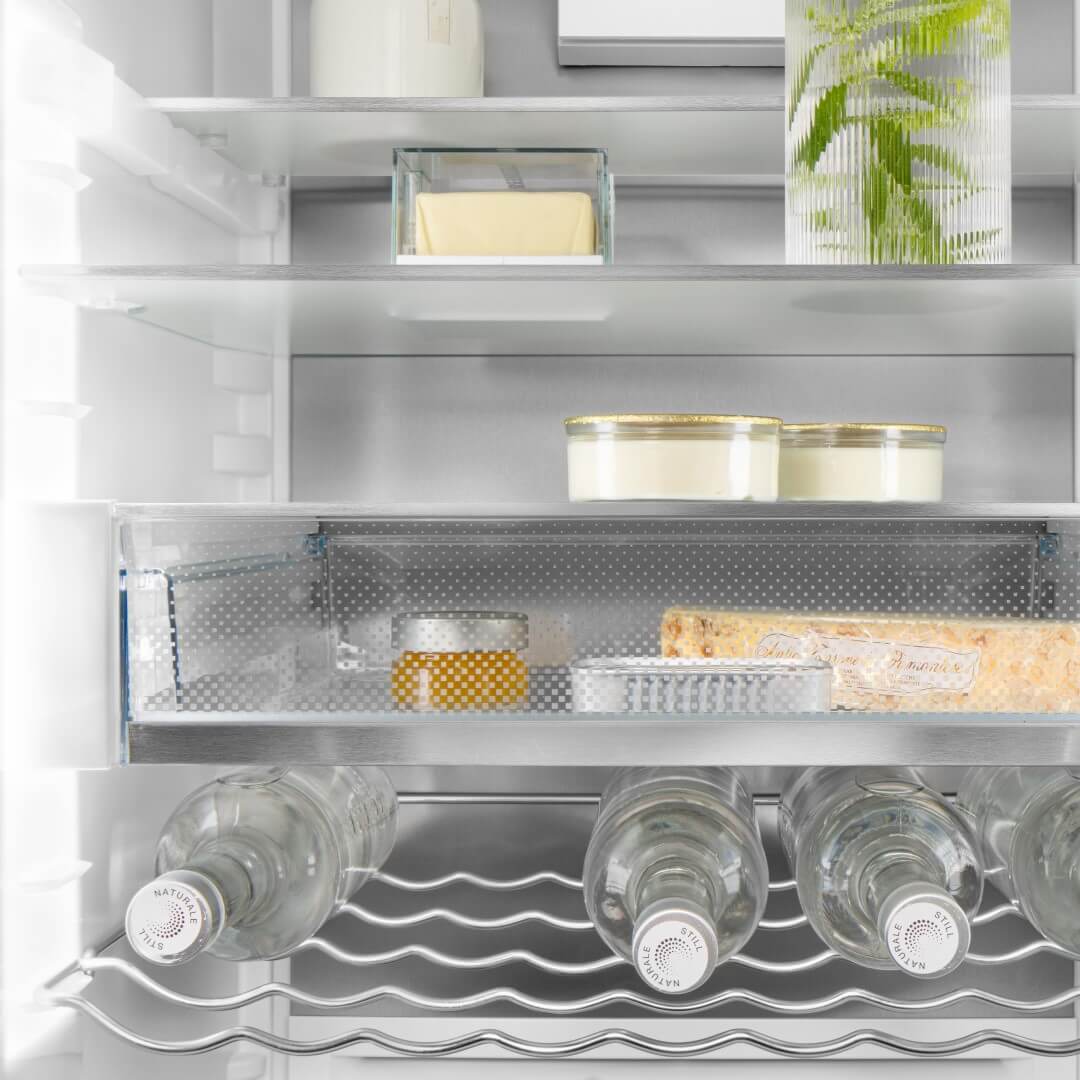 Close up of inside of fridge showing bottle rack, VarioSafe and shelves with food and drink on