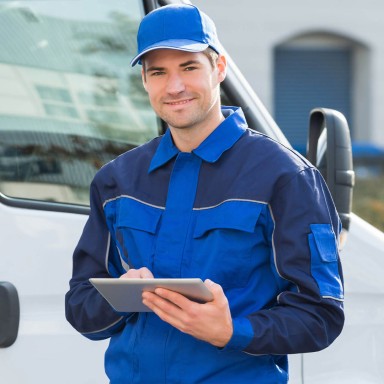 Engineer stood in front of van door.