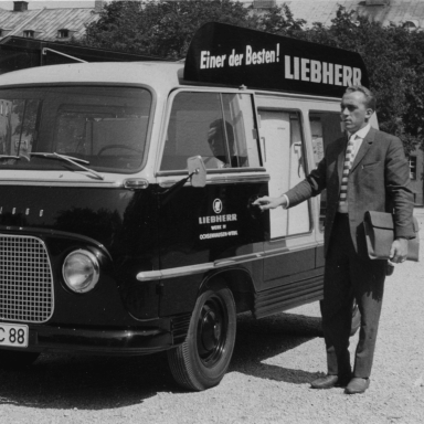 Hans Liebherr walking towards the front of the fridge van with an open side showing Liebherr fridge freezers