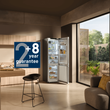 Modern open kitchen with a Liebherr fridge-freezer and a blue +8-year guarantee icon