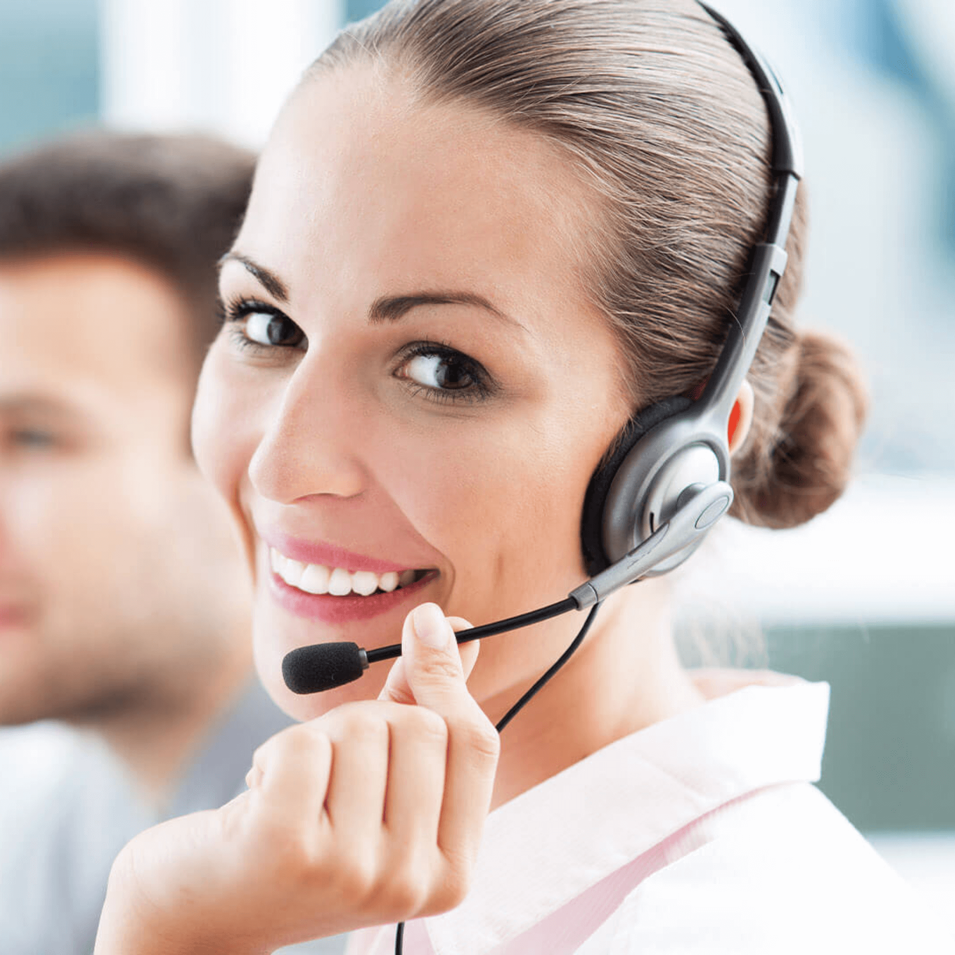 Customer service person on the phone with headset smiling at the camera