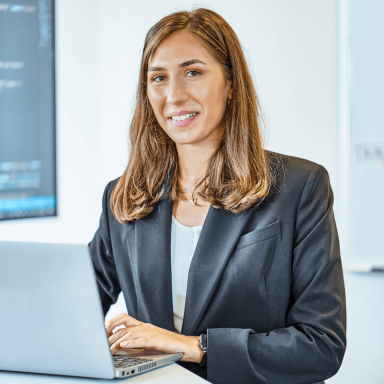 Customer services person on the computer smiling at the camera