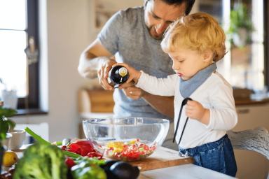 Child cooking with their father