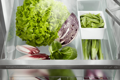 Open drawer fridge with organised vegetables