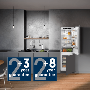 Integrated fridge freezer with two guarantee icons showing a +3 and a +8 with a large 2 to show the extension from a 2 year manufactuers guarantee to a 5 year or 10 year