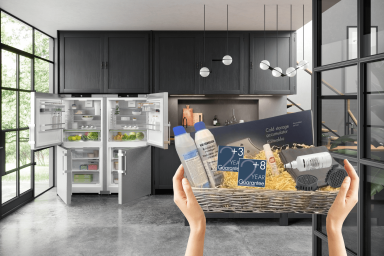 side by side fridge freezer in the background of a close up on a hamper with a multitude of products