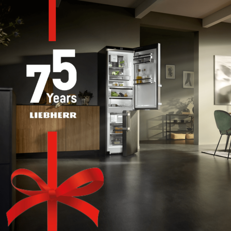 Open door fridge freezer in a modern kitchen with red ribbon at the side and 75 years in the middle