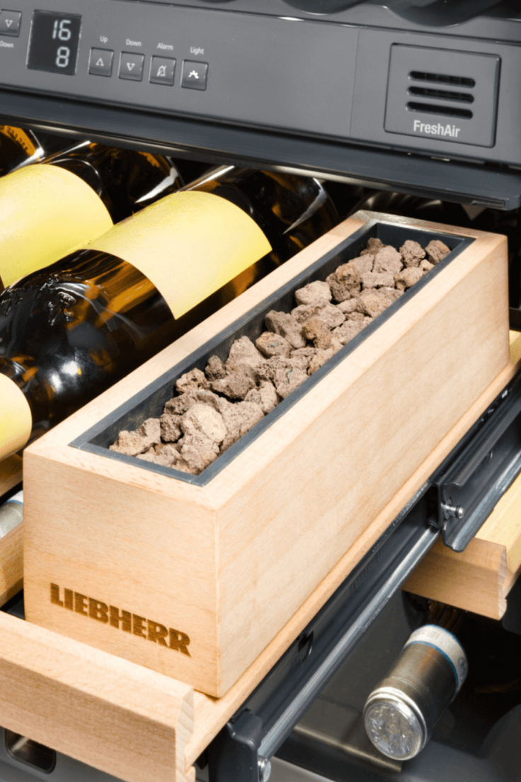 Close up of lava stones in a wooden box in a wine fridge