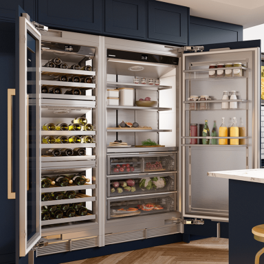 Close up of an open fridge and wine fridge door next to each other both very large hoding items inside