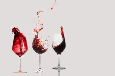 multiple glasses of wine with red wine contained and swirled in the glass