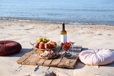 picnic on a beach with a wine bottle