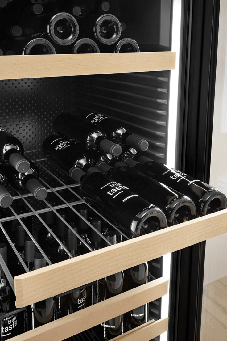 Pulled out wine shelf showing a bottle of wine 