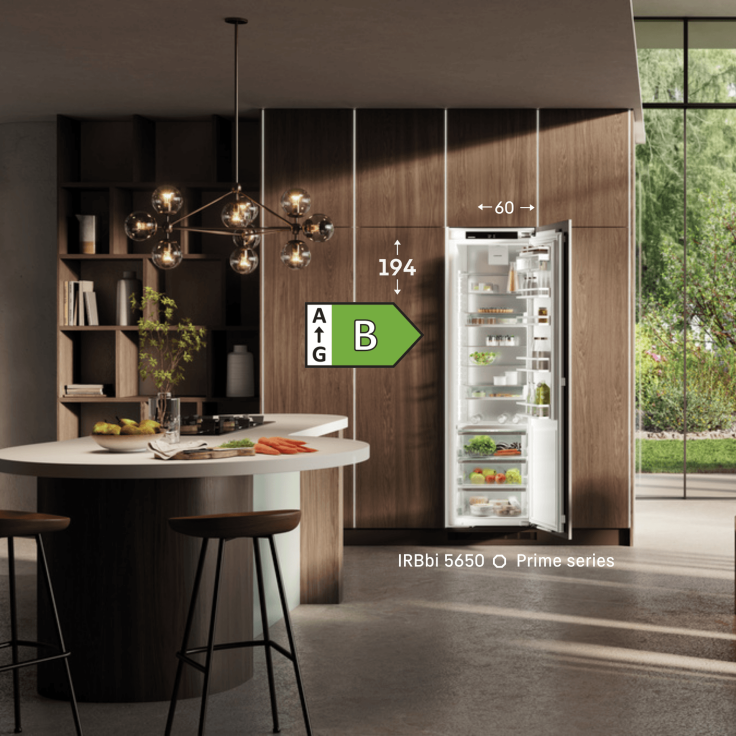 IRBbi5650 Liebherr fridge Open door Liebherr integrated fridge in a modern kitchen with icons showing the energy rating, height and width of the appliance.