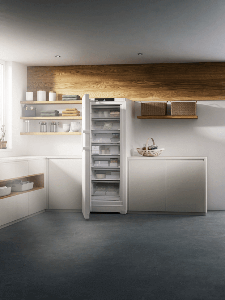 Open door freezer with a Liebherr EasyTwist ice maker in a modern kitchen