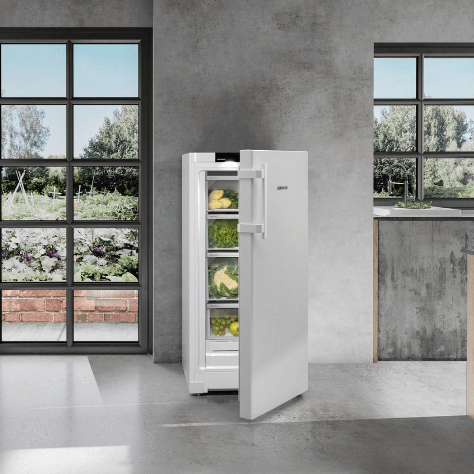 Close up of a freezer with a slightly open door showin frozen food in a modern kitchen