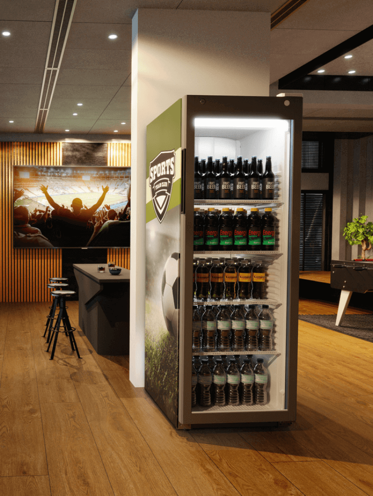 Pub with a drinks fridge with branded beers inside