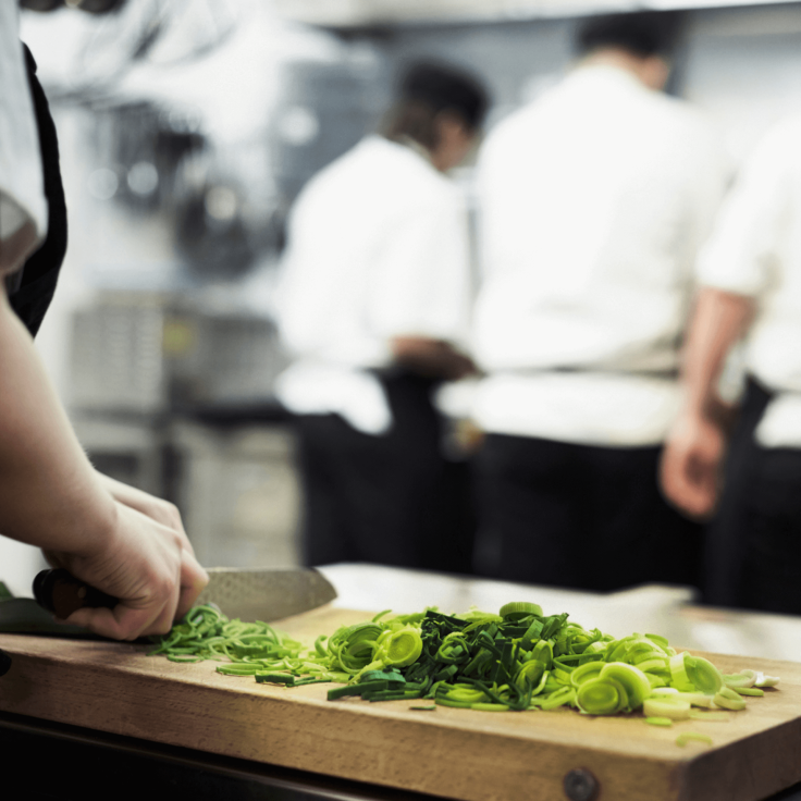 Close up of a chef chopping vegetables