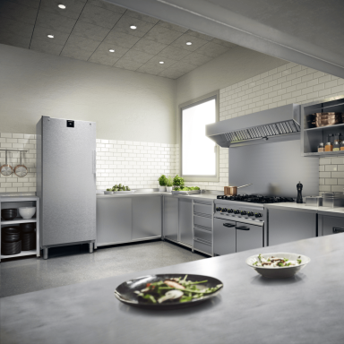 Close up of a fridge with a closed door  in a large professional kitchen