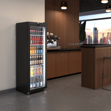 Close up of a glass door drinks fridge with drink bottles inside in a bar