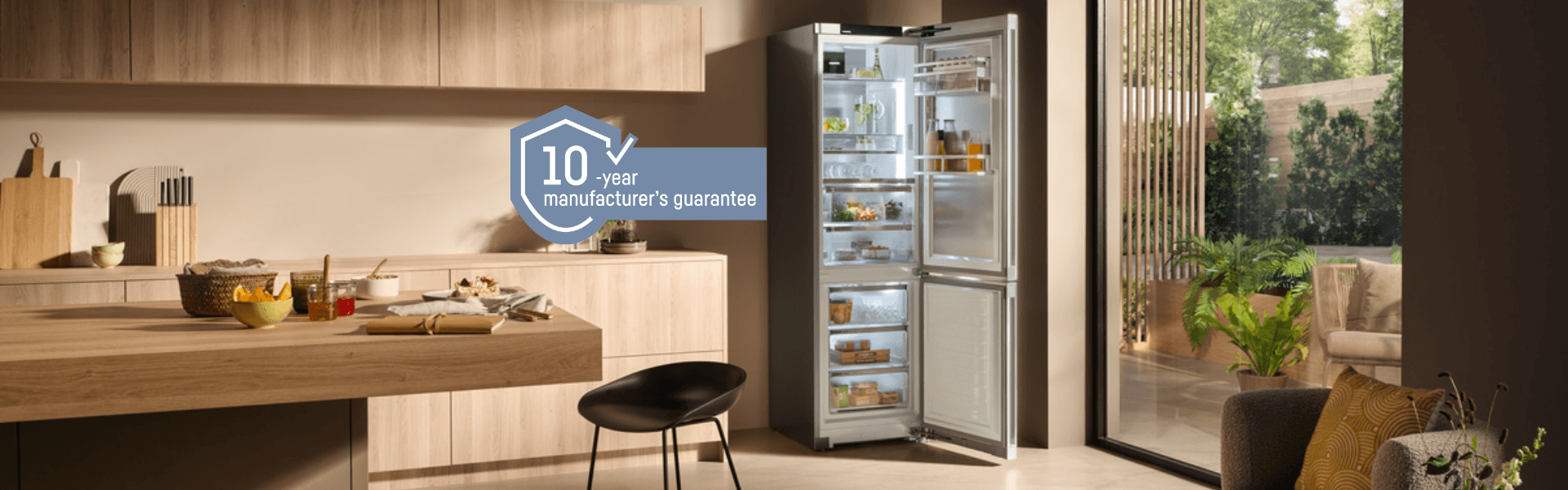 Freestanding Liebherr fridge-freezer with a 10-year guarantee logo Freestanding Liebherr fridge-freezer in an open modern kitchen with a blue 10-year guarantee logo