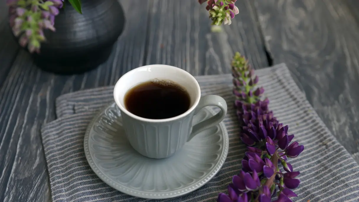 Lupin coffee White mug with lupin coffee on saucer, decorated with lupin blossoms.