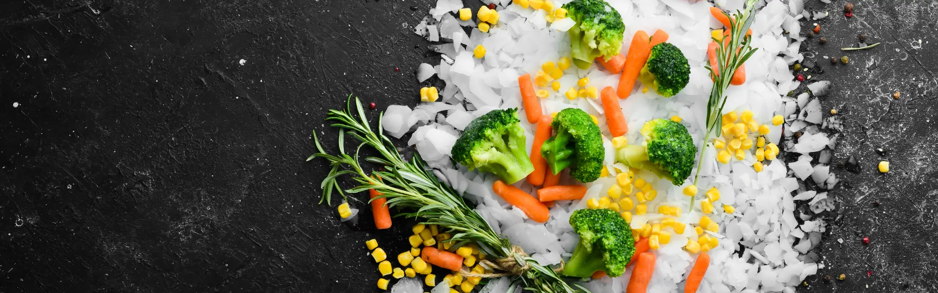 Healthy frozen food Frozen vegetables on flake ice with rosemary.