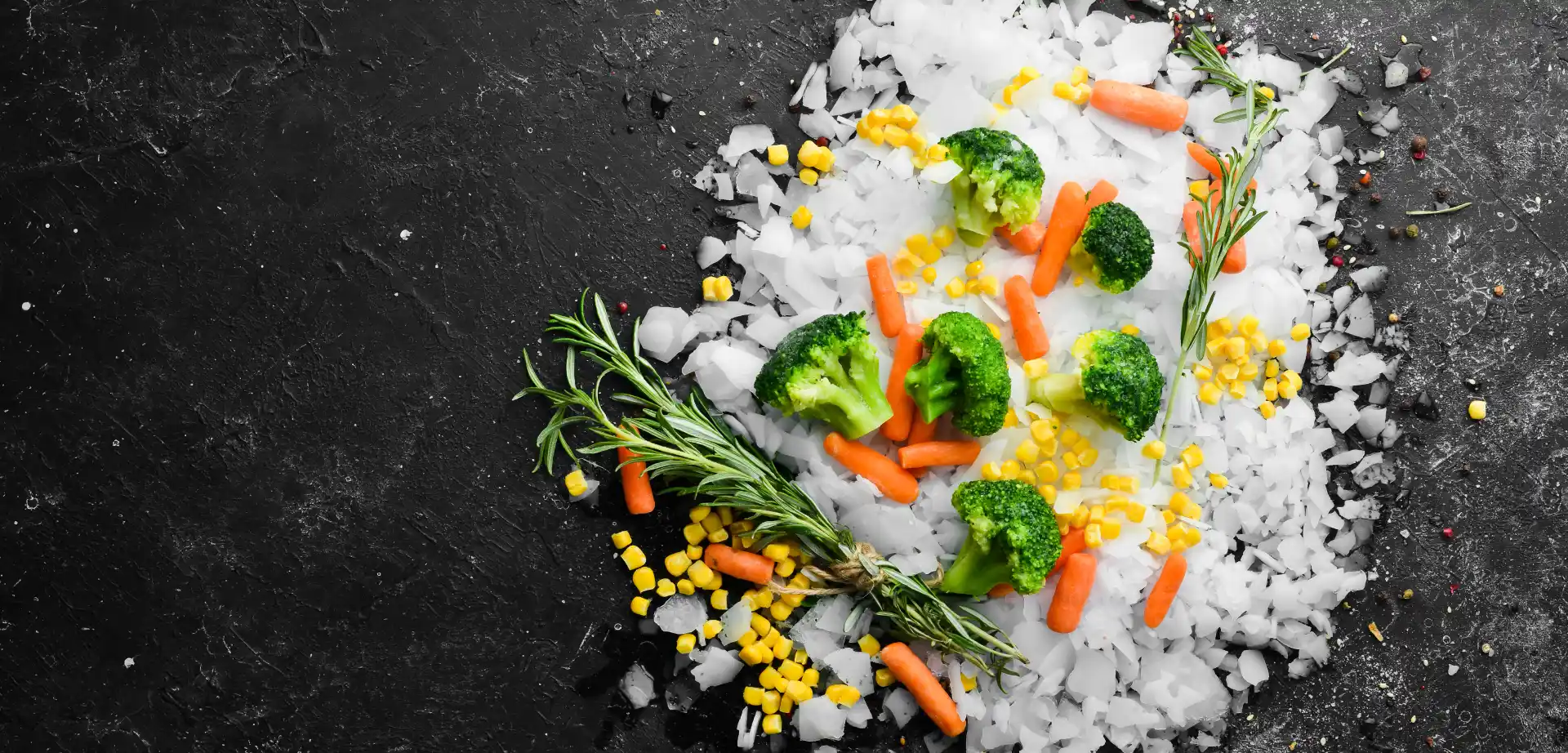 Healthy frozen food Frozen vegetables on flake ice with rosemary.
