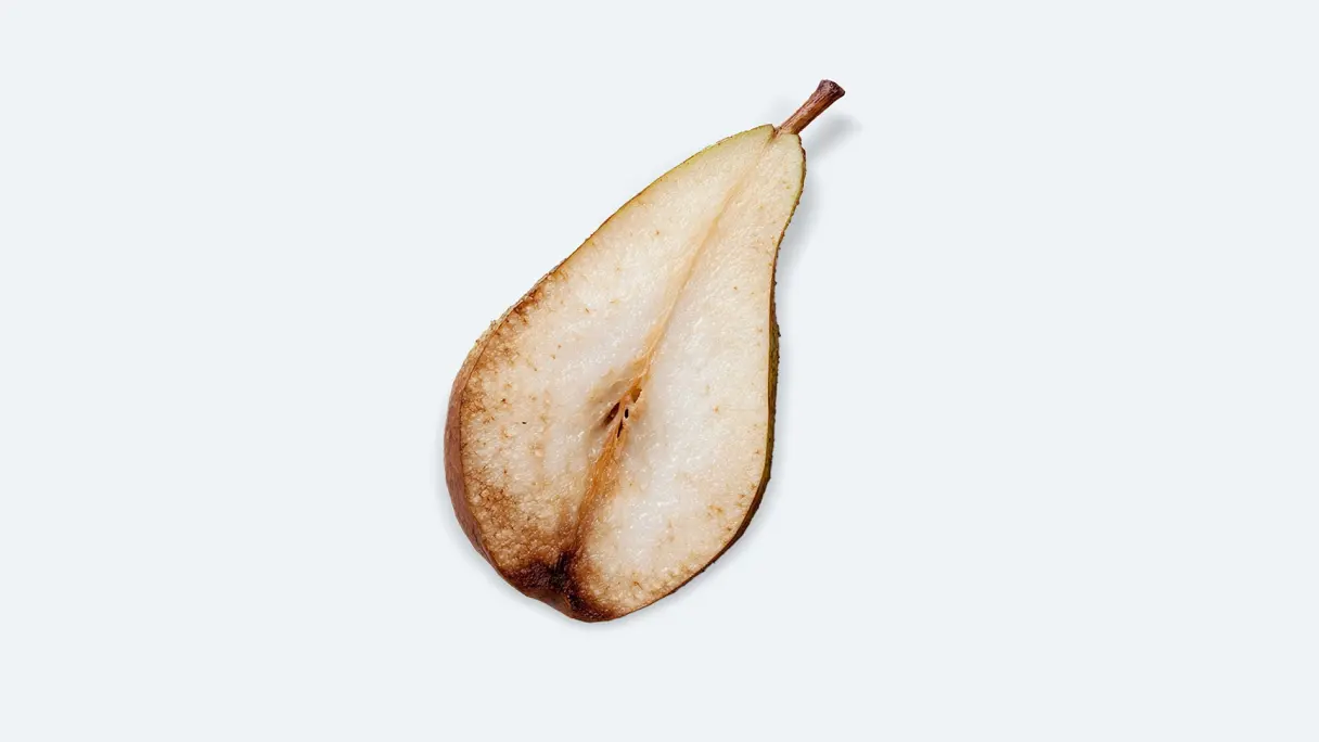 Halved pear stored for 55 days in a standard fridge compartment, showing visible browning.