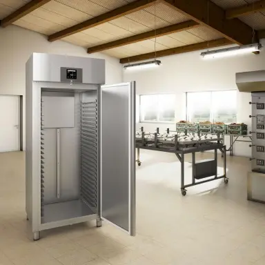 Silver bakery fridge with open door in a commercial kitchen