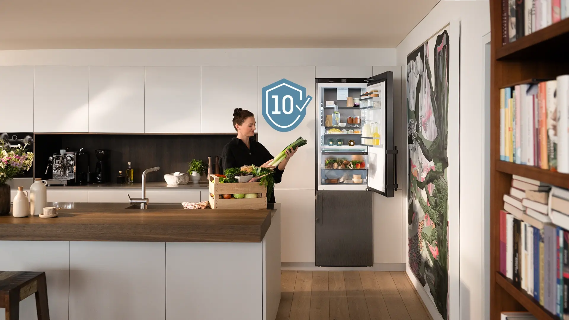 Verena Konrad beside a Liebherr fridge; “10-year manufacturer’s warranty” displayed in the image.