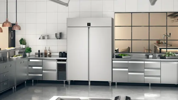 The FRPSvh 1402 food service fridge is prominently displayed in a clean, modern professional kitchen. Its sleek stainless steel finish enhances the kitchen's aesthetic, reflecting a commitment to hygiene and efficiency.
