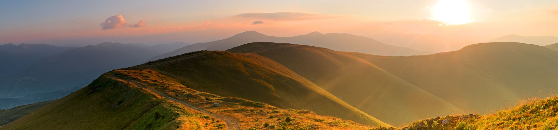 Sonnenaufgang über einem Bergpfad – Symbol für den Weg zu nachhaltigem Fortschritt und Verantwortung.
