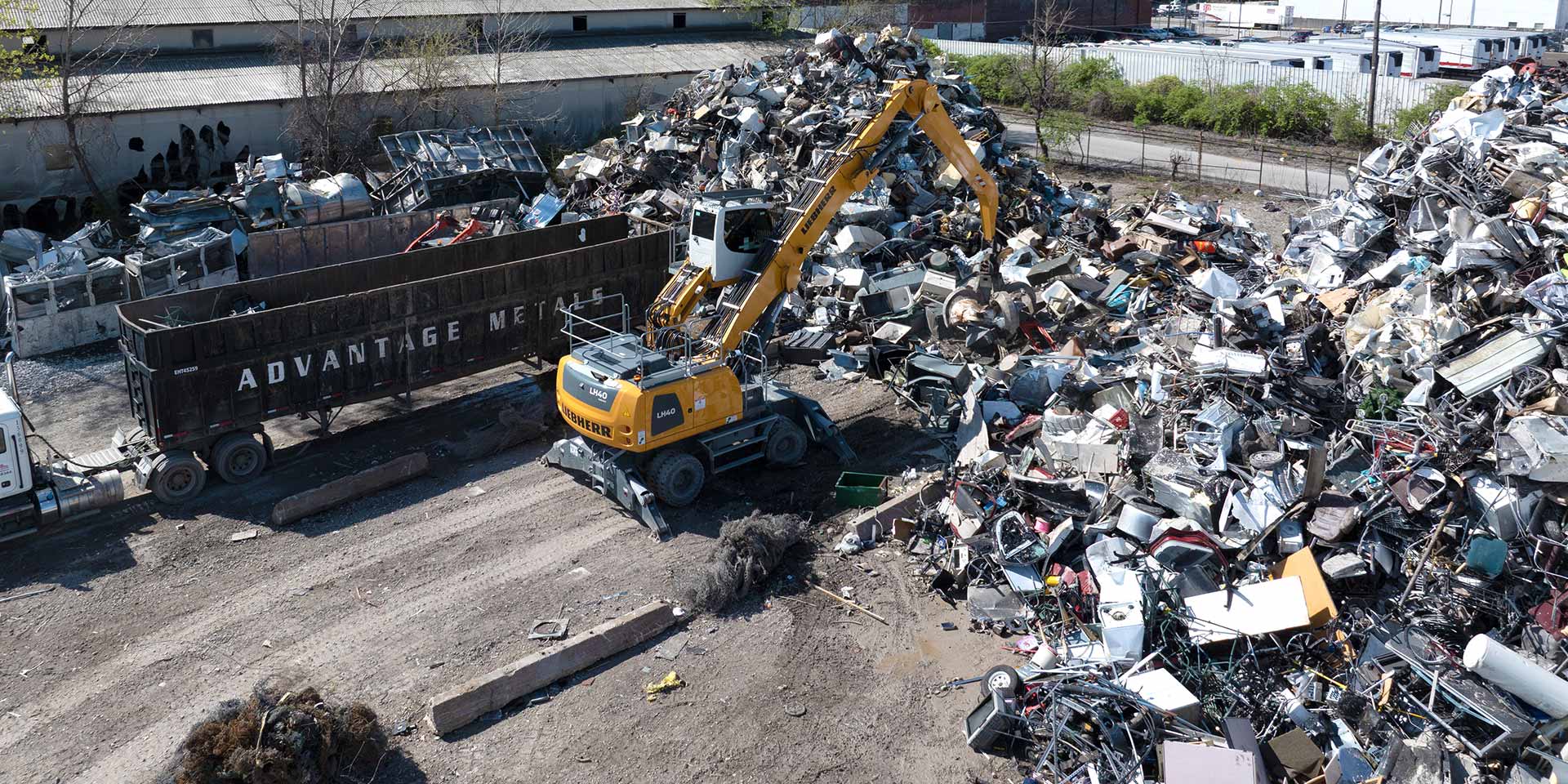 Liebherr USA, Co. LH 40 M material handling machine with grapple sorting scrap at the RIMCO scrap yard in St. Louis. Image of a Liebherr USA, Co. LH 40 M material handling machine with grapple sorting scrap at the RIMCO scrap yard in St. Louis.