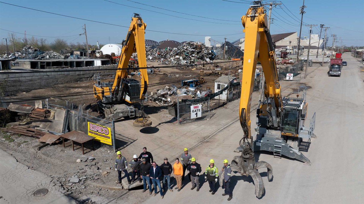 The RIMCO group personnel standing in front of two Liebherr USA, Co. LH 40 material handlers at the scrap yard in St. Louis. Image of the RIMCO group personnel standing in front of two Liebherr USA, Co. LH 40 material handlers at the scrap yard in St. Louis.