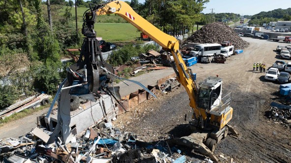 TAS Recycling team using Liebherr equipment to dismantle end-of-life vehicles for sustainable metal recovery.