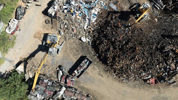 Liebherr material handler lifting and sorting scrap metal at TAS Recycling facility in Knoxville, Tennessee.