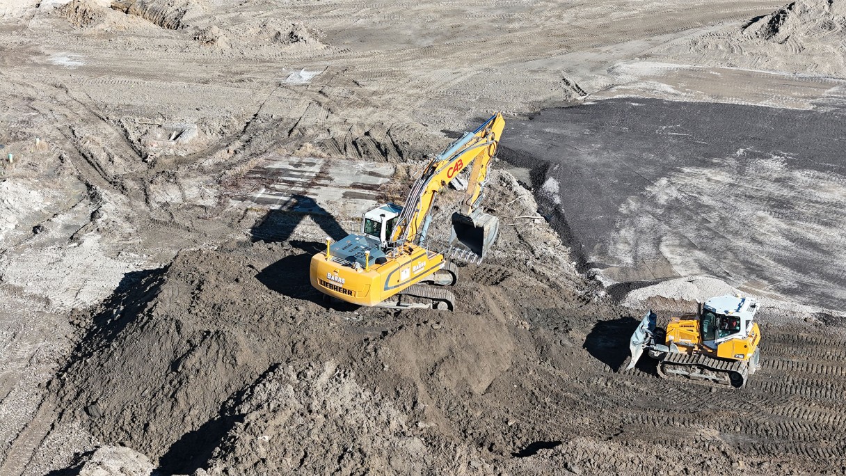 C.A. Barrs is using a  yellow Liebherr R946 crawler excavator and a yellow PR 716 dozer with trimble grading  to clear 8 acres for additional storage of machines at the back of Liebherr Mining Equipment Newport News,  Virginia campus.