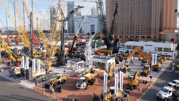 Aerial view of the Liebherr outdoor exhibition at CONEXPO 2023 in Las Vegas, featuring a wide range of cranes, excavators, wheel loaders, and construction machinery.
