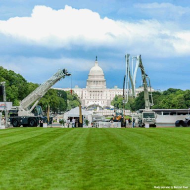 Liebherr USA, Co. tent exhibit at Construction on the National Mall. Exhibits include an LRT 1090-2.1 rough terrain crane, 42 XXT concrete pump truck, L 546 wheel loader.