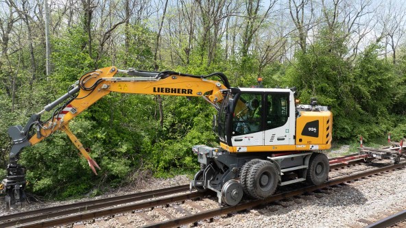 Image of Omaha Track, Inc. using the Liebherr A 924 rail excavator to perform railroad infrastructure  reclamation, abandoned track removal, new construction, track expansion, track maintenance, track inspections, and track repair on the Norfolk Southern railroad line.