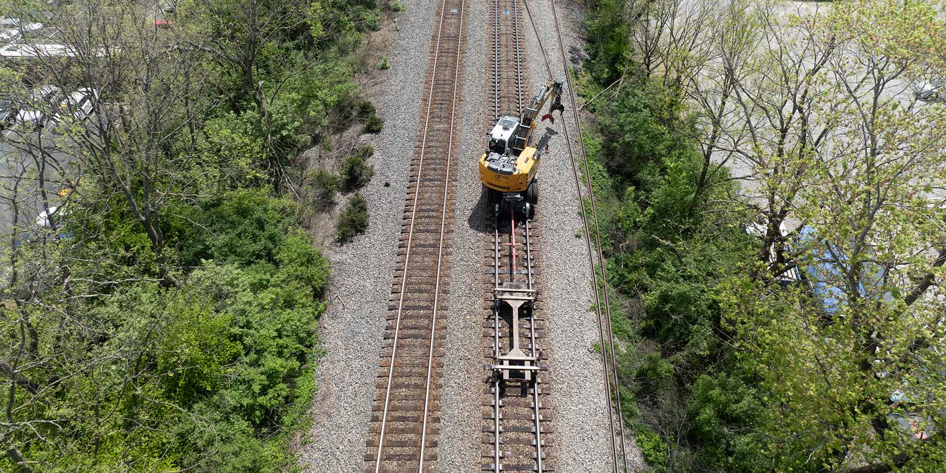 Omaha Track, Inc. using  the Liebherr A 924 rail excavator to perform railroad infrastructure  reclamation, abandoned track removal, new construction, track expansion, track maintenance, track inspections, and track repair on the Norfolk Southern railroad line.
