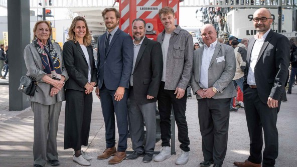 Representatives from Liebherr, Morrow, and Crazy Horse Memorial Fund post together at Bauma 2025. 