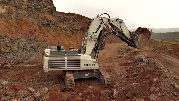 Hawaii Cement's white Liebherr R 9150 mining excavator digging aggregates in the Halawa Valley Quarry.