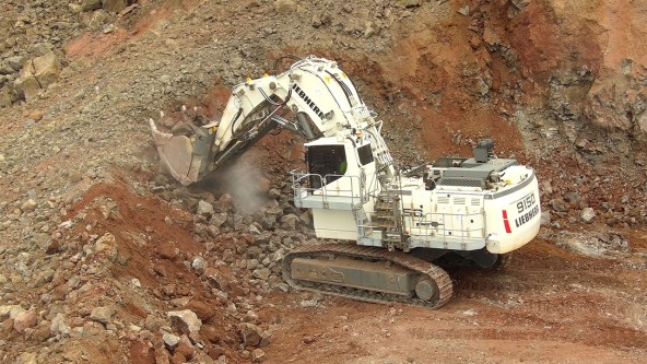 White Liebherr R 9150 mining excavator digging aggregates in the Halawa Valley Quarry