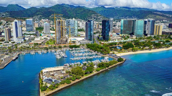 Beautiful view of Honolulu City in O'ahu, Hawaii with mountains in the background.